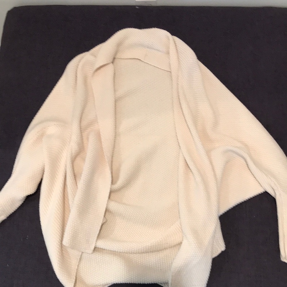 Cream colored batwing knitted cardigan.